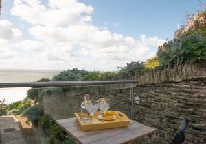 a tray with glasses on a table overlooking the ocean at 3 Little Beach in Woolacombe