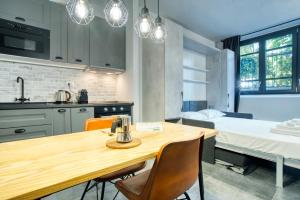 a kitchen and dining room with a wooden table and chairs at Italianflat - Angolino dei navigli in Milan