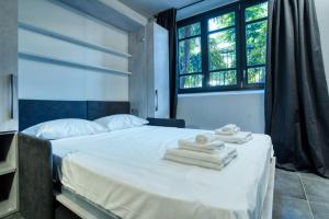 a bedroom with a bed with towels on it at Italianflat - Angolino dei navigli in Milan