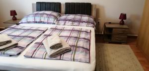 a bedroom with a bed with blankets and pillows at Új Lilla Apartman in Keszthely +36 photos