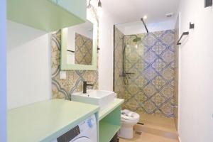 a bathroom with a sink and a toilet and a shower at Kaminaki Beachfront Apartments in Nisaki