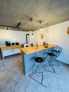 a kitchen with a island with two bar stools at Casa Mona in Gonzerath