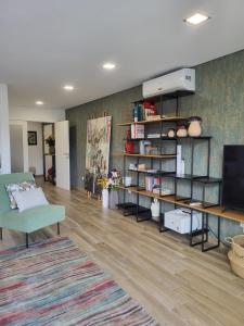 a living room with a couch and a television at NORTHEAST PORTUGAL G in Mirandela