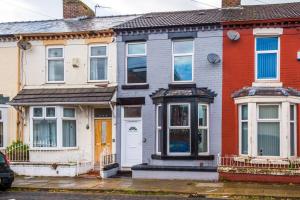 a house with a white door on a street at Mansa Musa House - 5 Bed 5 En Suite Bathrooms, Newly Refurbished House with free parking outside in Liverpool