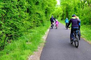 a group of people riding bikes down a trail at Maison de charme in Nouzonville