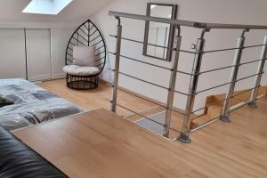 a living room with a metal ladder and a chair at Maison de charme in Nouzonville