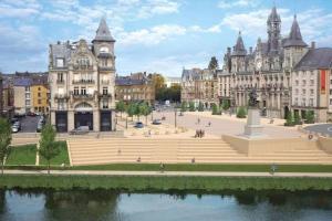 a large building with a fountain in the middle of a city at Maison de charme in Nouzonville +15 photos