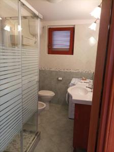 a bathroom with a toilet and a sink and a shower at Casa Fiori in Pisciotta
