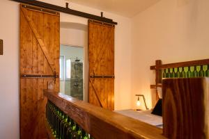 a bedroom with a wooden barn door and a bed at Dům u lázní in Znojmo