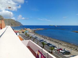 a view of a harbor with cars parked next to the water at Apartamento en primera línea de mar, las Teresitas, Santa Cruz de Tenerife in San Andrés