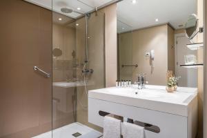 a bathroom with a sink and a shower at INNSiDE by Meliá Alicante Porta Maris in Alicante