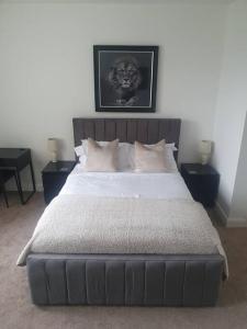 a bedroom with a large bed with two night stands at Apartment in Failsworth in Manchester