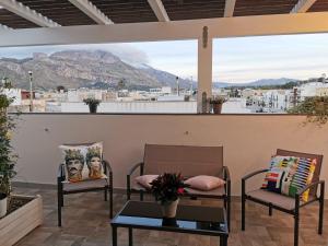 a balcony with two chairs and a view of a mountain at SOLE MIO Vacation in San Vito lo Capo