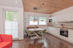 a kitchen with a table and chairs in a room at Haus Sonnenheim in Längenfeld