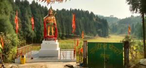 a large statue of a man standing in a field at Blessing Homestay Ahaldara in Mangpu