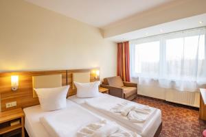 Postel nebo postele na pokoji v ubytování Ferien Hotel Rennsteigblick