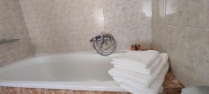 a bathroom with a bath tub with towels on it at ANASA in Stavros +52 photos