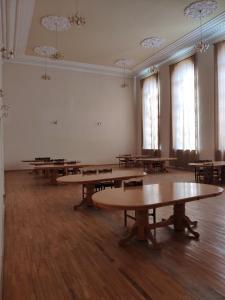 a large room with tables in it with windows at Health Resort Arzni 1 in Arzni