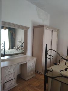 a bedroom with a vanity and a large mirror at Health Resort Arzni 1 in Arzni