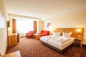 Postel nebo postele na pokoji v ubytování Ferien Hotel Rennsteigblick