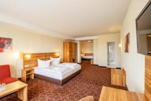Postel nebo postele na pokoji v ubytování Ferien Hotel Rennsteigblick