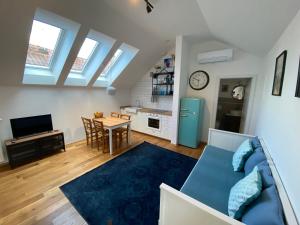 a living room with a blue couch and a table at Krakovska apartments in Ljubljana