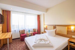 Postel nebo postele na pokoji v ubytování Ferien Hotel Rennsteigblick