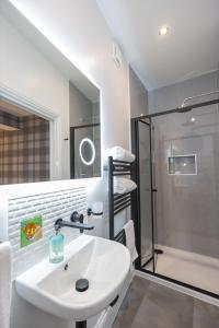 a bathroom with a white sink and a shower at Aye Stay in Inverness