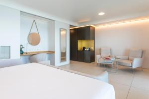 a room with a bed and a table and chairs at INNSiDE by Meliá Alicante Porta Maris in Alicante