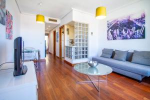 a living room with a couch and a table at Castilla Luz Deco in Madrid