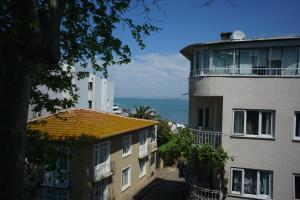 a view of the ocean from between two buildings at My Way Cadde Butik Otel in Adalar