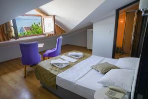 a bedroom with a bed and a desk and a window at My Way Cadde Butik Otel in Adalar
