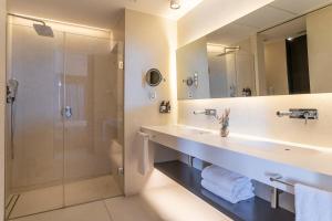 a bathroom with a sink and a shower at INNSiDE by Meliá Alicante Porta Maris in Alicante
