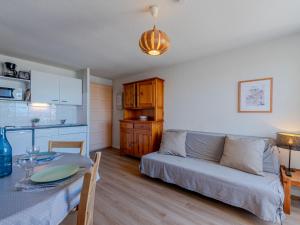 a living room with a couch and a table at Apartment Front de Mer-8 by Interhome in Le Barcarès