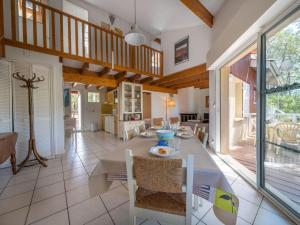 a kitchen and dining room with a table and chairs at Holiday Home Golf Loisirs-4 by Interhome in Lacanau-Océan