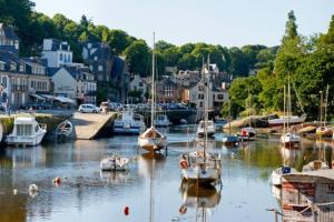 a bunch of boats are docked in a harbor at Maison en bois avec piscine à 1000 m des plages. in Guidel