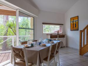 a dining room with a table and chairs at Holiday Home Golf Loisirs-4 by Interhome in Lacanau-Océan