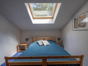 a bedroom with a bed and a skylight at Holiday Home Golf Loisirs-4 by Interhome in Lacanau-Océan +29 photos
