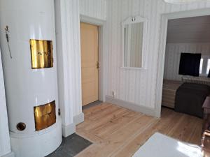 a room with a hallway with a door and a couch at Kristbergs Rusthåll in Borensberg