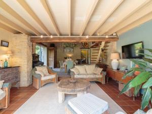 a living room with a couch and a table at Holiday Home Moulin De Mois by Interhome in Joussé