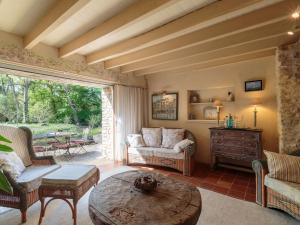 a living room with a couch and a table at Holiday Home Moulin De Mois by Interhome in Joussé