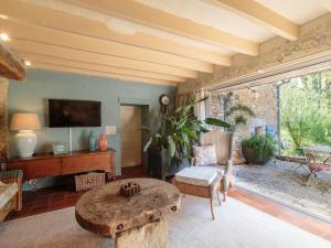 a living room with a table and a couch at Holiday Home Moulin De Mois by Interhome in Joussé