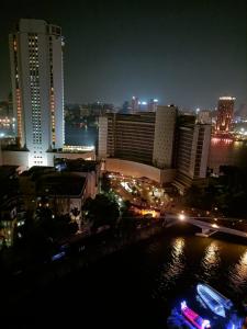 a view of a city at night with buildings at Nile view apartment in Cairo
