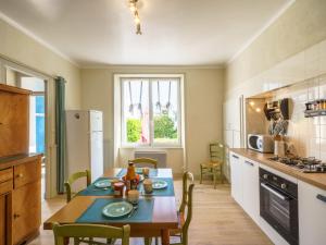 a kitchen with a table and chairs in a room at Holiday Home Ty Martelod - SGU108 by Interhome in Saint-Guénolé