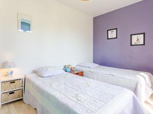 two beds in a room with purple walls at Holiday Home Colibri by Interhome in Saint-Germain-sur-Ay
