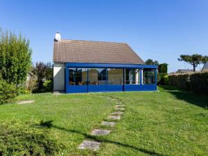 a house with a blue roof and a grass yard at Holiday Home Colibri by Interhome in Saint-Germain-sur-Ay