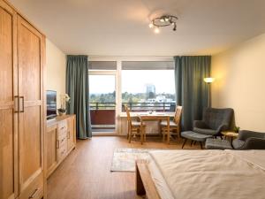a hotel room with a bed and a table and chairs at Apartment B907 by Interhome in Lahnstein