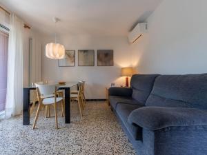 a living room with a blue couch and a table at Apartment Mas Baixuli by Interhome in Tarragona