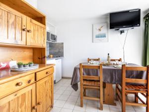 a kitchen with a table and a dining room at Apartment Les Capitelles by Interhome in Saint-Cyprien-Plage