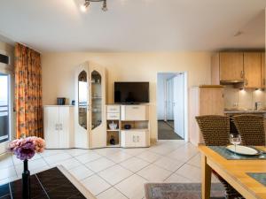 a kitchen and living room with a tv and a table at Apartment B1101 by Interhome in Lahnstein +24 photos